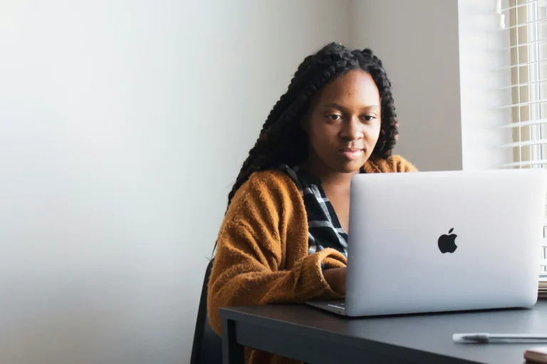 a young graduate using a laptop